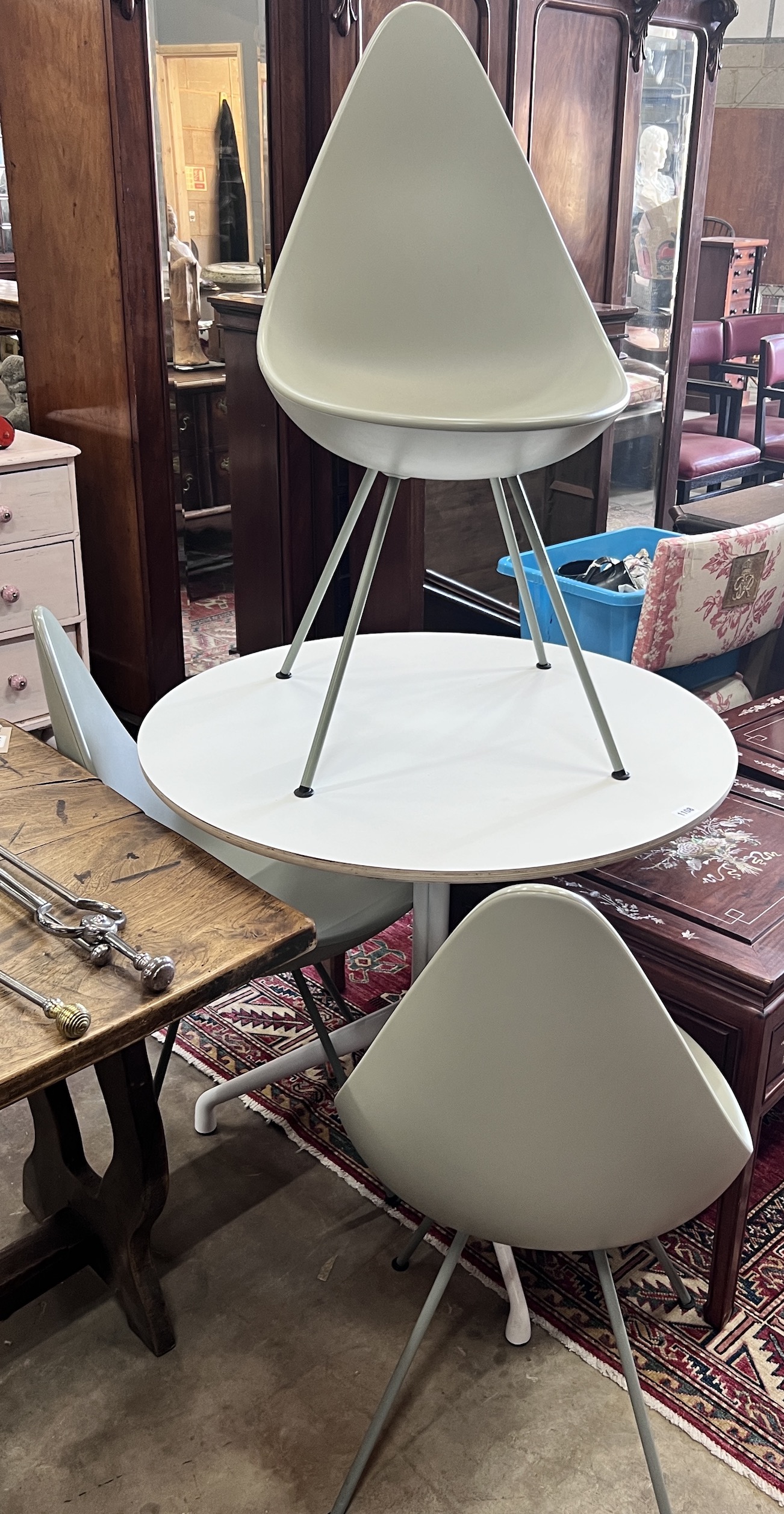 Arne Jacobsen for Fritz Hansen, three 'drop' chairs and a Hay Productions circular table, diameter 80cm, height 74cm